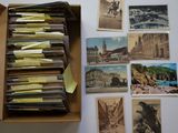 an open box filled with lots of old postcards sitting on top of a table