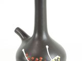 a black vase with a design on it