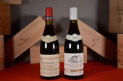 two bottles of wine sitting next to each other on a table