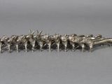 a silver figurine of a herd of cattle