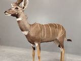 a statue of a large antelope standing in a room