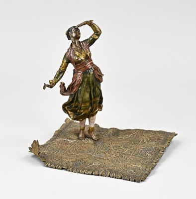 bronze statue of a woman with a basket on her head