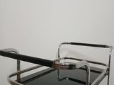 a black and chrome serving cart with a glass top