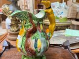 a vase with a bird on it sitting on a table
