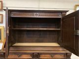 an old wooden cabinet with two doors open on a white surface