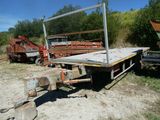 un camion à plateau garé sur un terrain en terre battue