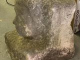a stone block sitting on a table next to a book