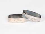 two silver rings with the names of men and women on them