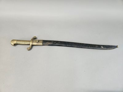 a close up of a knife on a white surface with a black handle