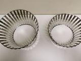 two empty bowls sitting on a white surface