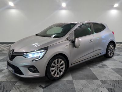 a silver car is parked on a checkered floor in a garage