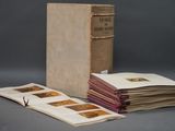 several old books are stacked on top of each other on a table