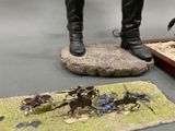 a statue of a man standing on a rock next to a statue of a man on a horse