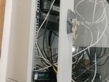 a wall mounted computer with a bunch of wires on it