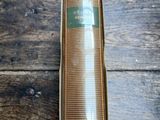 an image of a bottle of perfume sitting on top of a wooden table