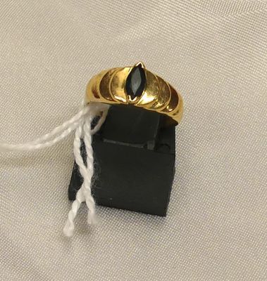 a gold ring with a black stone on top of it