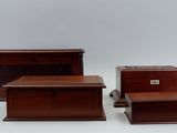 three pieces of furniture including a chest, chest, and stool