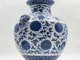a blue and white vase sitting on a white surface