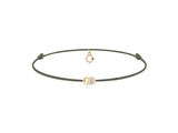un bracelet en or orné d'un diamant et d'un cordon noir