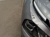 a close up of a car ' s headlight on the street