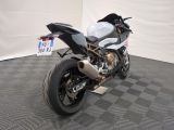 a motorcycle that is sitting on a black and white checkered floor