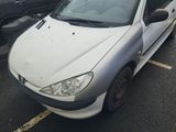 a white car parked in a parking lot with other cars in the background