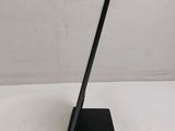 the back of a black tablet computer sitting on top of a white table