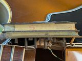 a close up of a guitar with a guitar picker attached to it