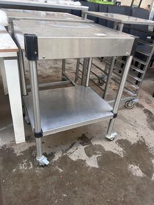 a stainless steel table with a metal shelf on it
