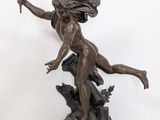 bronze statue of a woman holding a torch in her hand