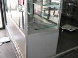 a glass display case in the middle of a room