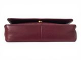 the burgundy leather clutch bag is open and ready to be used