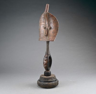 a bronze sculpture of a woman ' s head on a wooden base