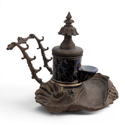 a black and gold teapot sitting on top of a table