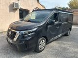 a black van parked in front of a building in a parking lot