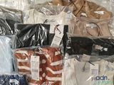 many different types of shirts wrapped in plastic bags