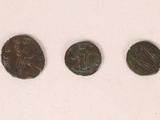 three roman coins, one of which has a woman and one of which is a man
