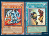 two cards of a dragon and a man fighting each other in front of a blue background