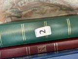 three books stacked on top of each other in a bag