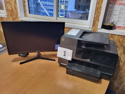 two computer monitors on a desk with a printer on it