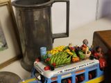 a toy bus with a bunch of fruit on top of it