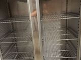 an empty freezer with two doors open in a kitchen