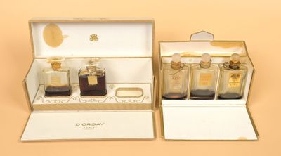 three bottles of perfume sitting in a box on a table