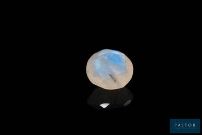 a moons stone on a black surface with a black background