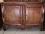 a large wooden cabinet with a mirror on top of it