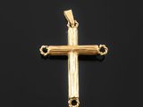 a gold cross pendant on a black background