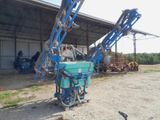 a blue machine that is sitting in the dirt