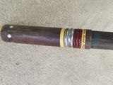 a wooden stick with a metal ring on it