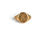 a close up of a gold signet ring with a monogram on it