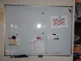 un tableau blanc sur lequel sont posés plusieurs feuilles de papier